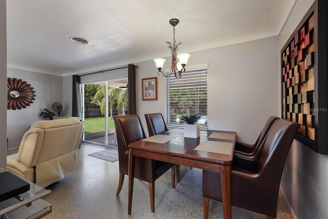 dining room with a notable chandelier