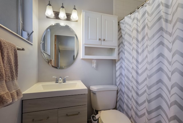 bathroom featuring toilet and vanity with extensive cabinet space