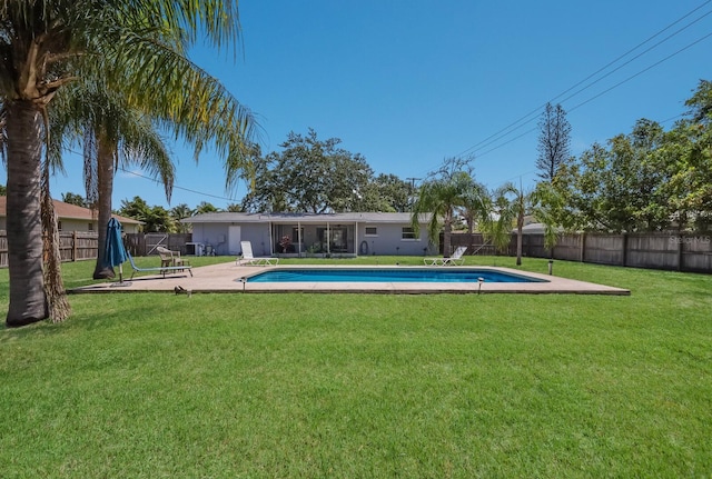 view of swimming pool with a lawn