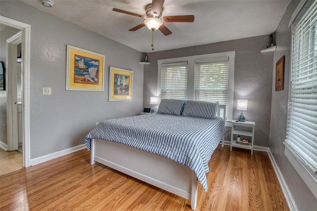 bedroom with ceiling fan and light hardwood / wood-style flooring