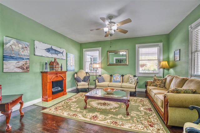 living room featuring ceiling fan, dark hardwood / wood-style flooring, and plenty of natural light