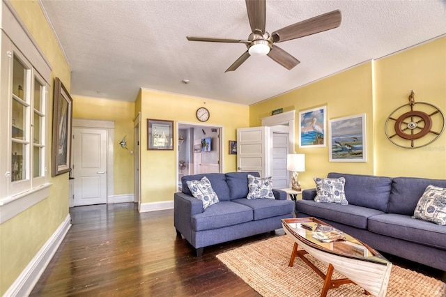 living room with a textured ceiling, ceiling fan, and dark hardwood / wood-style floors