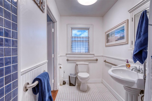 bathroom with tile patterned flooring and toilet