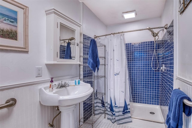 bathroom with tile patterned flooring, a shower with curtain, and sink