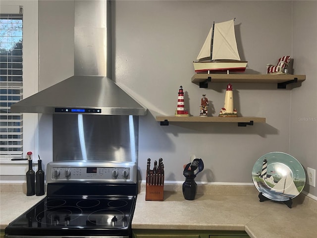 kitchen featuring black range with electric stovetop and wall chimney range hood