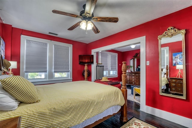 bedroom featuring a textured ceiling, dark hardwood / wood-style floors, and ceiling fan