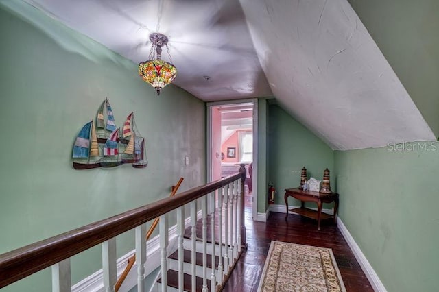 corridor featuring vaulted ceiling and dark hardwood / wood-style floors