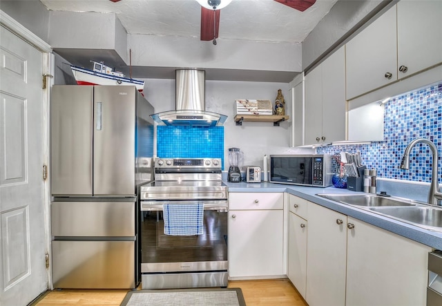 kitchen featuring white cabinets, appliances with stainless steel finishes, island exhaust hood, and sink