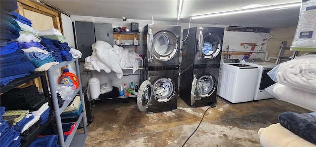 laundry room with separate washer and dryer, electric panel, and stacked washer and clothes dryer