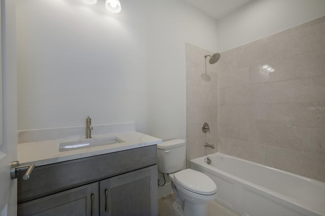 full bathroom featuring vanity, tiled shower / bath combo, and toilet