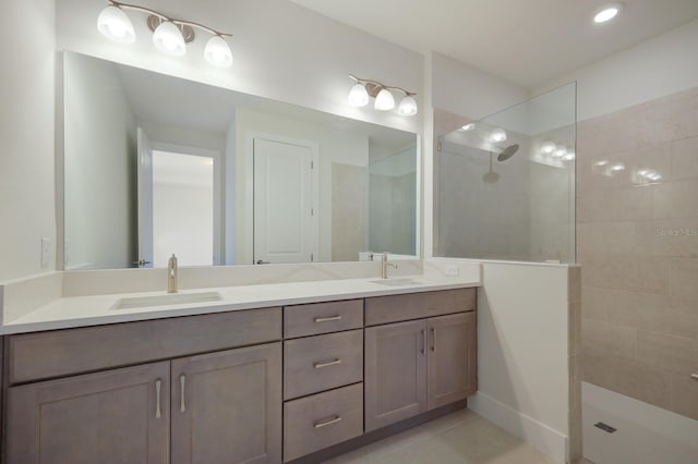 bathroom with vanity, tile patterned floors, and tiled shower