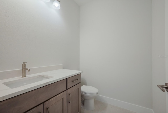 bathroom with tile patterned floors, toilet, baseboards, and vanity