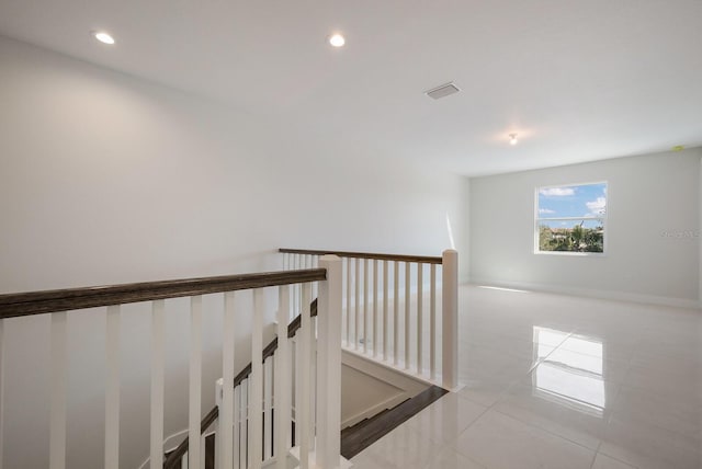 corridor featuring an upstairs landing, recessed lighting, baseboards, tile patterned floors, and visible vents