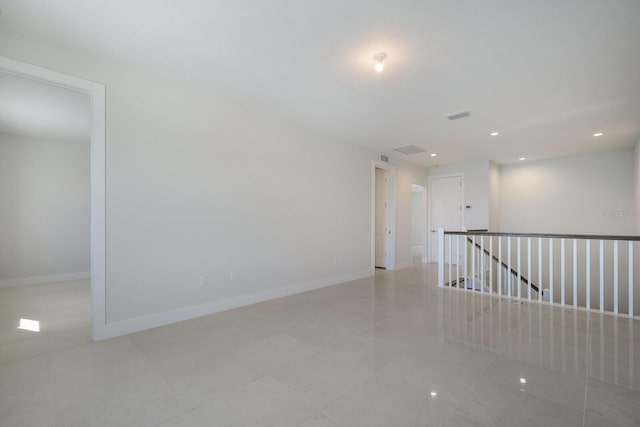 empty room with baseboards, visible vents, recessed lighting, and light tile patterned floors