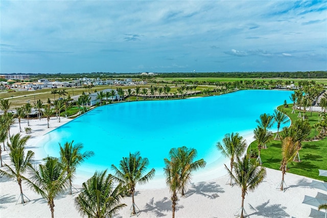 view of pool featuring a water view