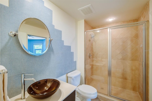 bathroom with toilet, a shower with door, and vanity