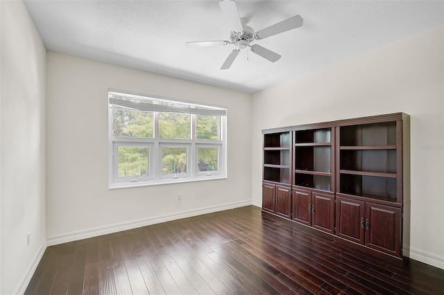 unfurnished room featuring ceiling fan and dark hardwood / wood-style flooring