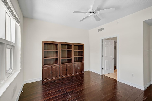 spare room with ceiling fan and dark hardwood / wood-style flooring