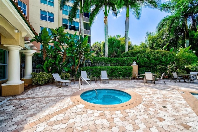 view of swimming pool with a patio area and a hot tub