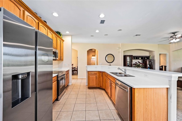 kitchen with ceiling fan, light tile flooring, sink, an island with sink, and stainless steel appliances