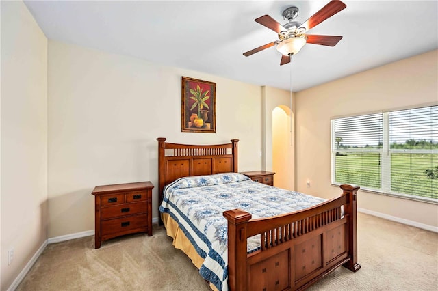 bedroom with light carpet and ceiling fan