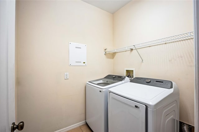 laundry room with washer hookup, washing machine and dryer, and light tile floors