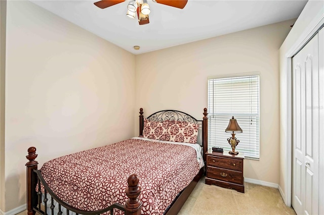 bedroom with light colored carpet, a closet, and ceiling fan