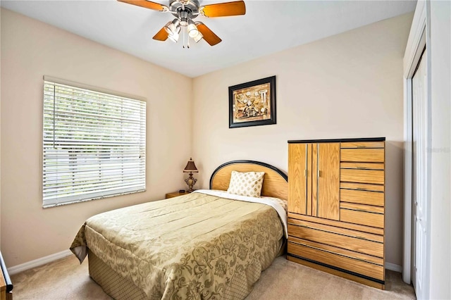 bedroom with light carpet, a closet, and ceiling fan