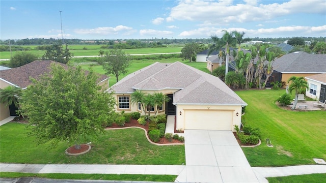 view of front of home with a front lawn and a garage