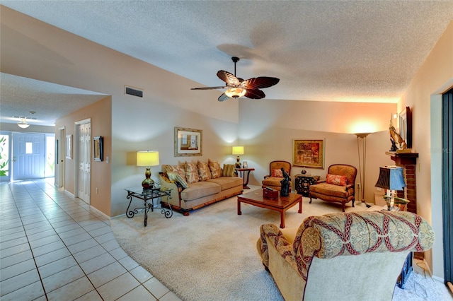 living room featuring light carpet, ceiling fan, and a textured ceiling