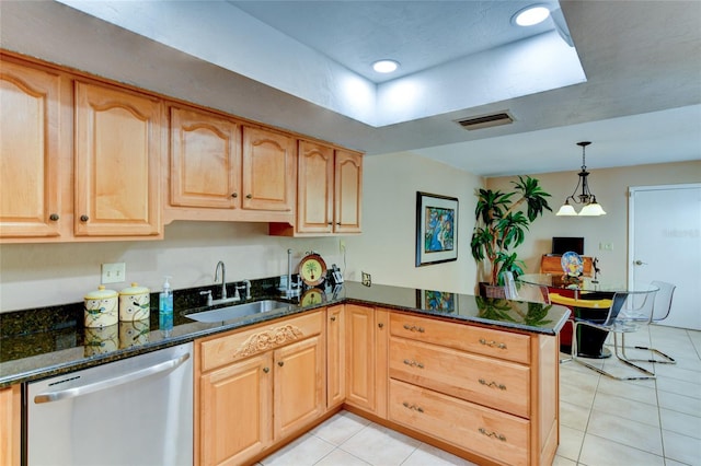 kitchen with pendant lighting, sink, dark stone counters, stainless steel dishwasher, and kitchen peninsula