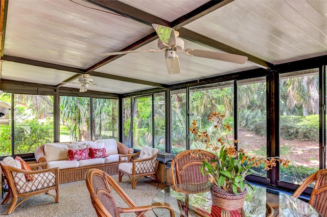 sunroom with beam ceiling and ceiling fan