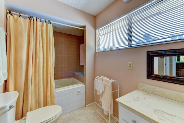 full bathroom featuring vanity, a textured ceiling, shower / bath combination with curtain, and toilet