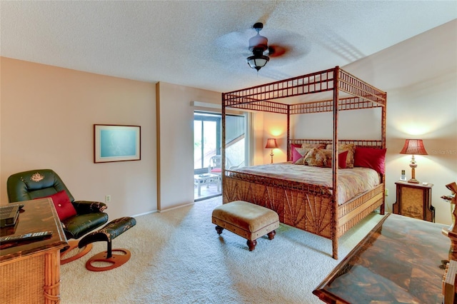 carpeted bedroom featuring ceiling fan, access to exterior, and a textured ceiling