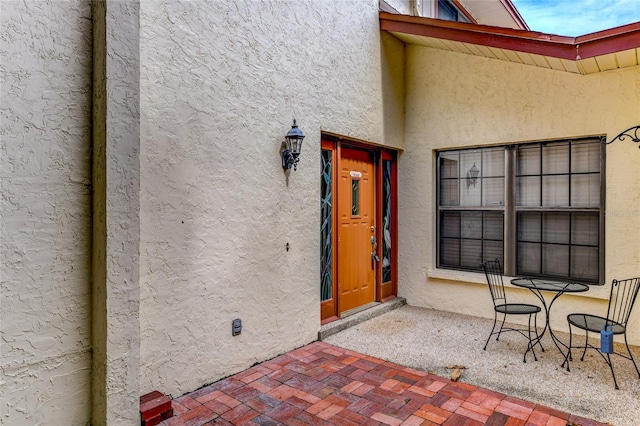 property entrance featuring a patio area