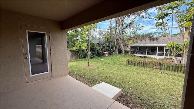 view of yard with a sunroom and a patio area