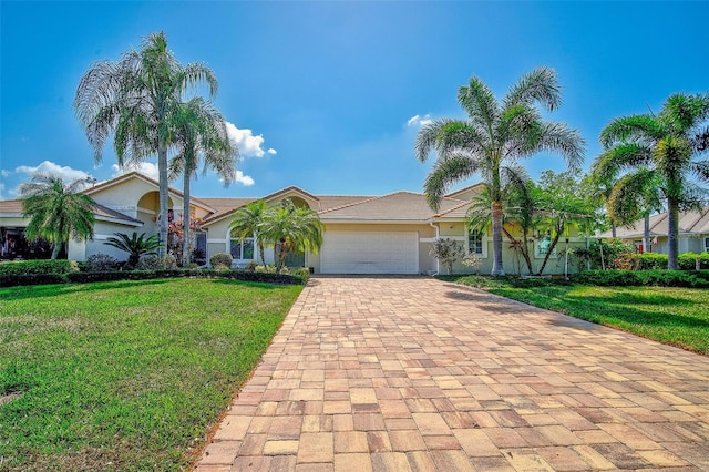 view of front of house with a front yard and a garage