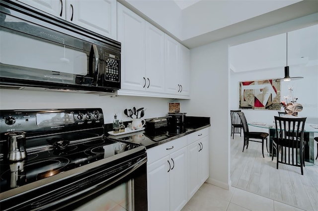 kitchen with light tile floors, white cabinets, and black appliances