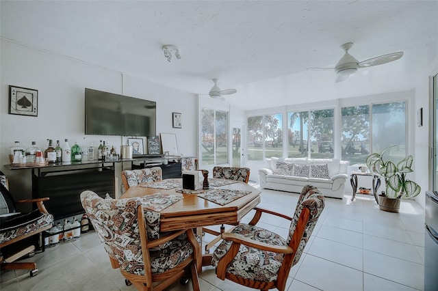 dining area featuring light tile floors and ceiling fan