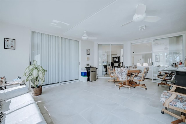 dining area with ceiling fan and light tile floors