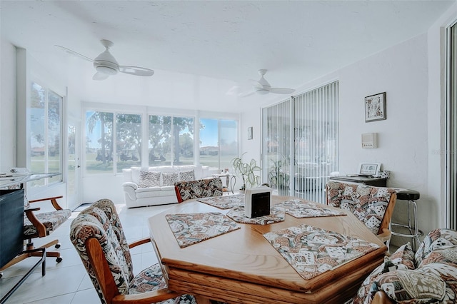 dining space featuring light tile floors and ceiling fan