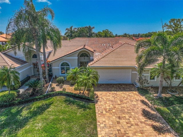 view of front of house with a front yard and a garage