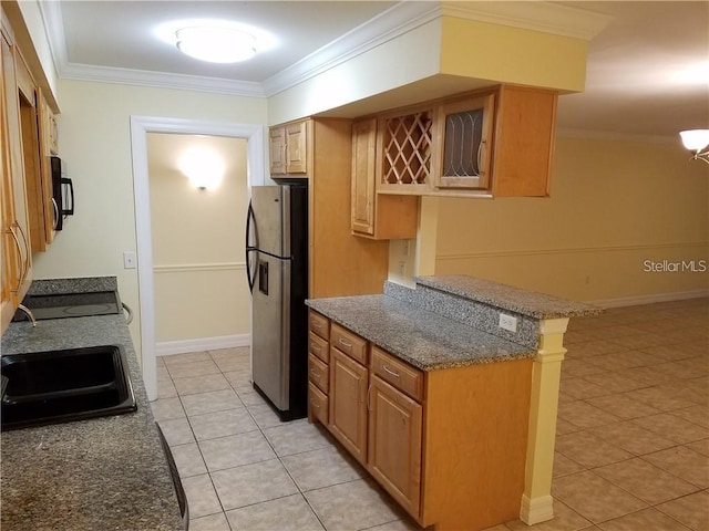 kitchen with light tile floors, appliances with stainless steel finishes, crown molding, dark stone countertops, and sink