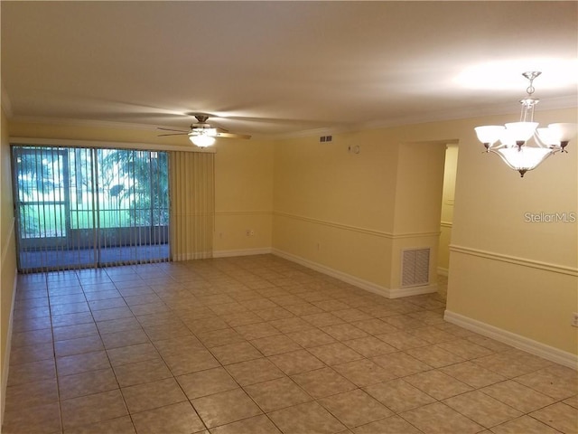 tiled spare room featuring crown molding and ceiling fan with notable chandelier