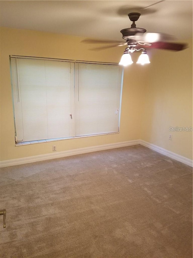 carpeted empty room with ceiling fan