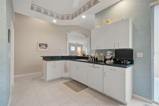 kitchen featuring tasteful backsplash, white cabinets, ceiling fan, and light tile floors