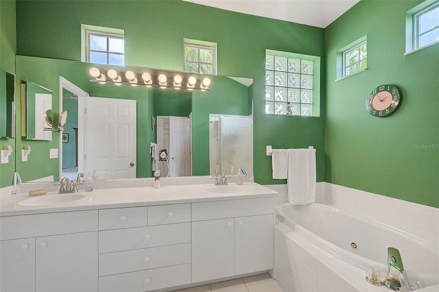 bathroom with oversized vanity, dual sinks, and a healthy amount of sunlight