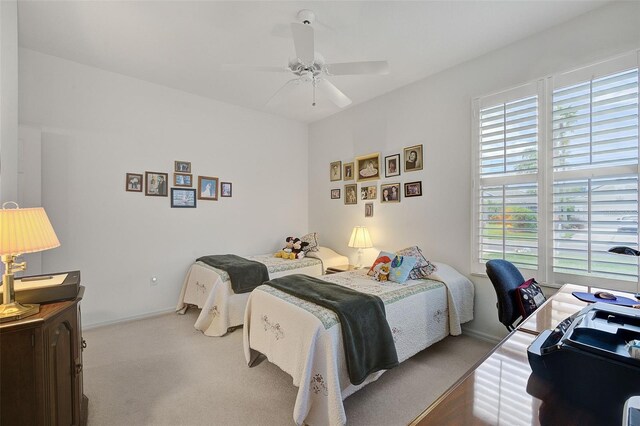 bedroom with light carpet and ceiling fan