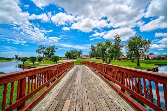 wooden terrace featuring a yard and a water view