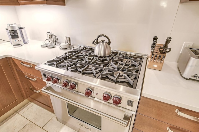 kitchen with double oven range and light tile floors